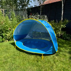 Little Cubs pop up beach tent with built-in pool set up on a sunny back garden lawn