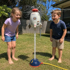 Two children watching a water-powered rocket sprinkler hover on a jet of water in an Australian backyard