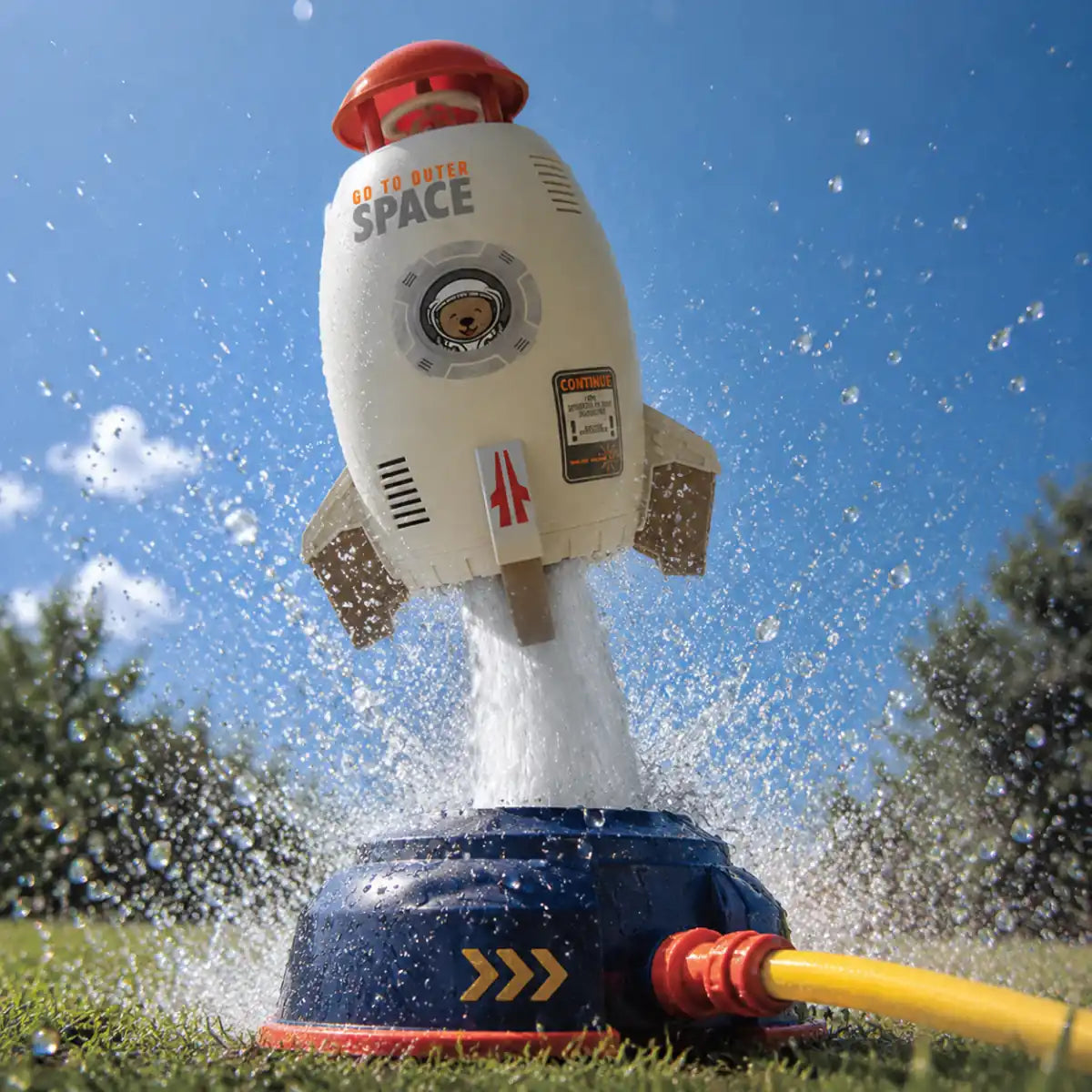 Close-up of the rocket sprinkler hovering upright on a column of water above its navy launch base