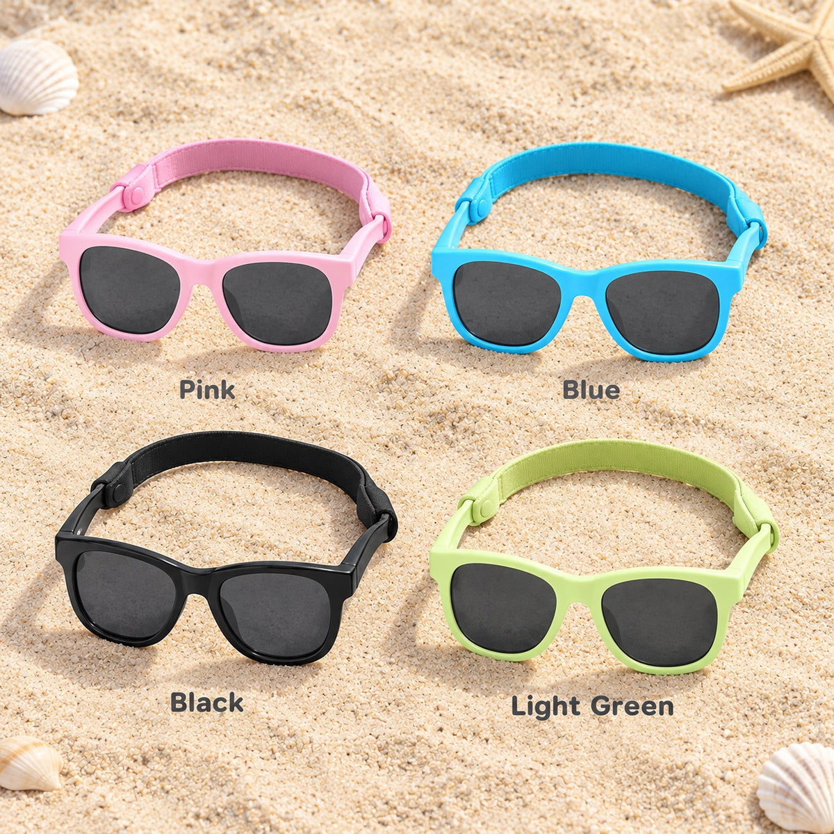 Baby sunglasses with strap in pink, blue, black and light green on beach sand