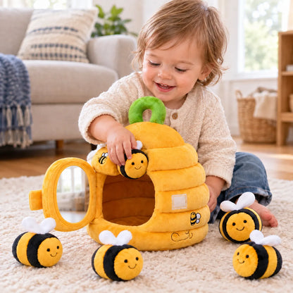 Toddler posting a plush bee into the soft beehive, mirrored door open beside it