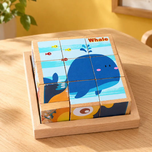 Wooden picture cube puzzle in its tray, all nine cubes turned to complete the whale picture
