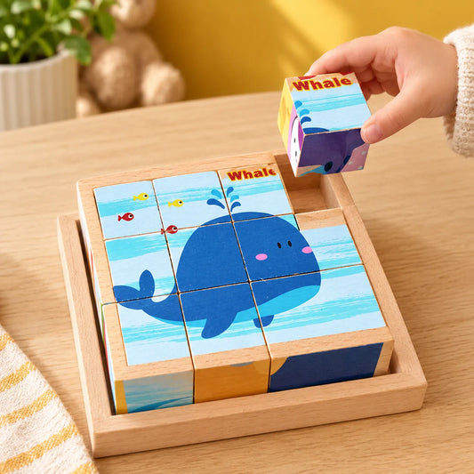 Wooden picture cube puzzle in its tray showing the whale picture, one cube held above