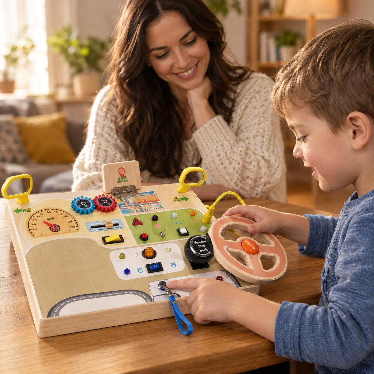 Boy playing with the wooden busy dashboard at the table while his mother watches