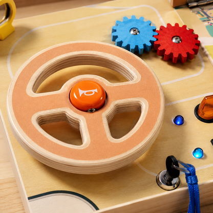Close-up of the salmon three-spoke steering wheel and horn button