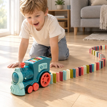 Boy watching the domino train lay a long curving line of coloured dominoes across the floor