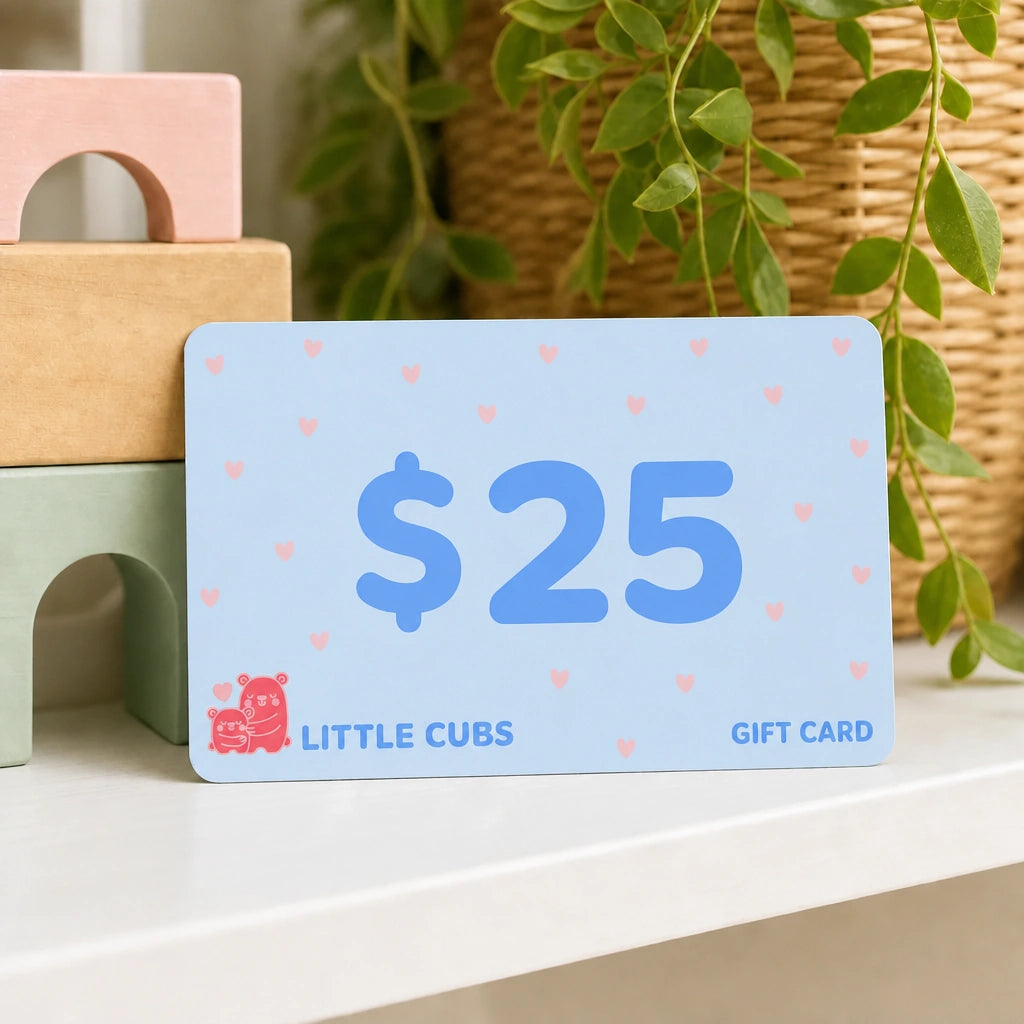 Little Cubs $25 gift card propped against wooden blocks on a nursery shelf