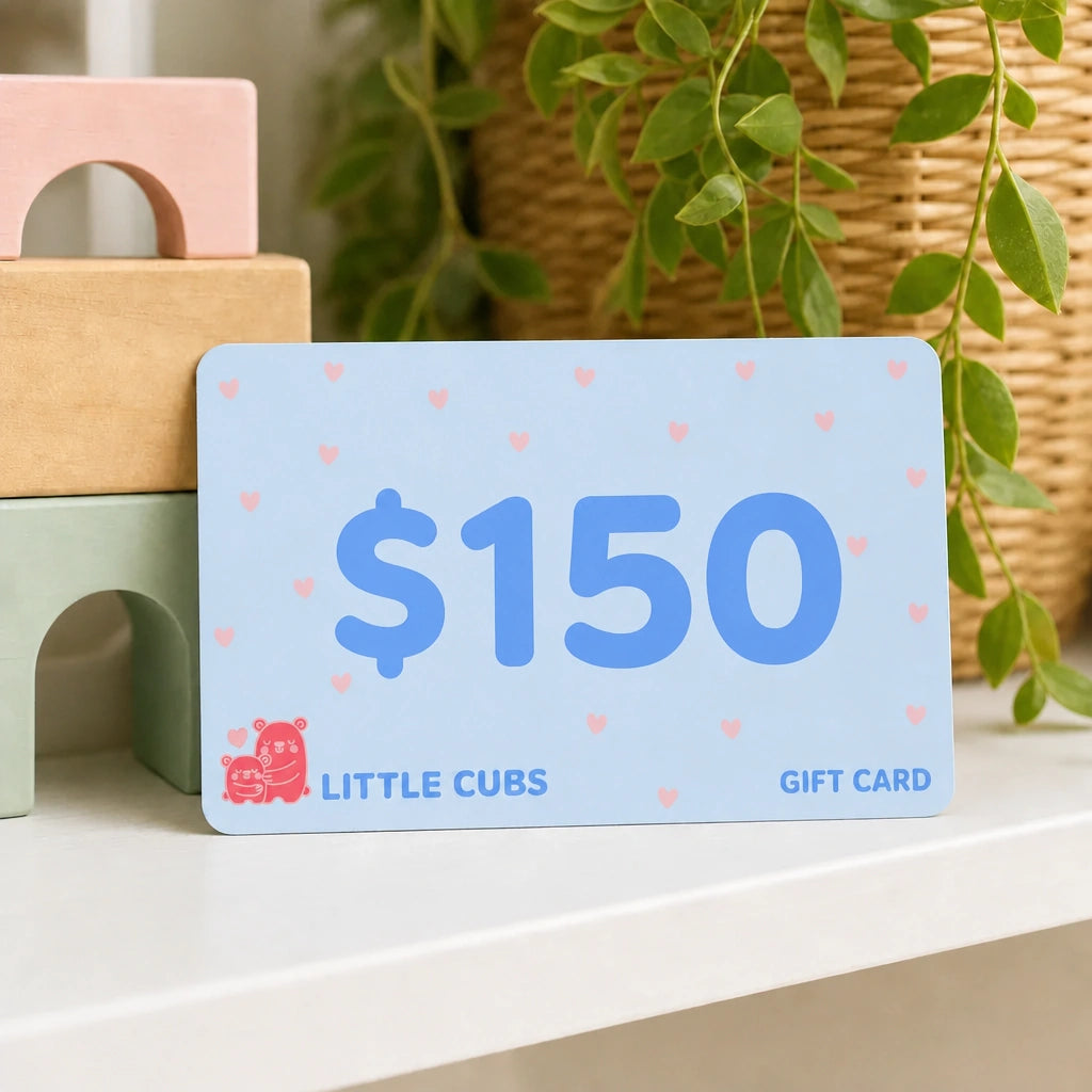 Little Cubs $150 gift card propped against wooden blocks on a nursery shelf