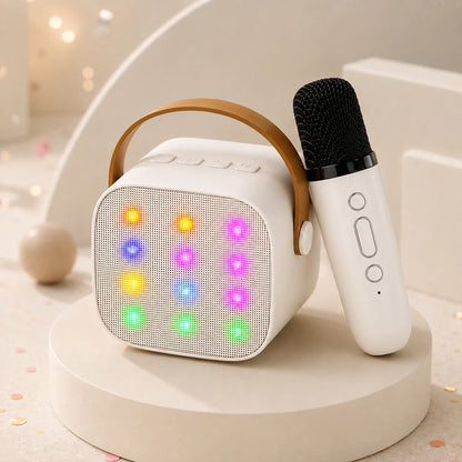 White kids karaoke machine with twelve colour-changing LED lights and its matching white wireless microphone