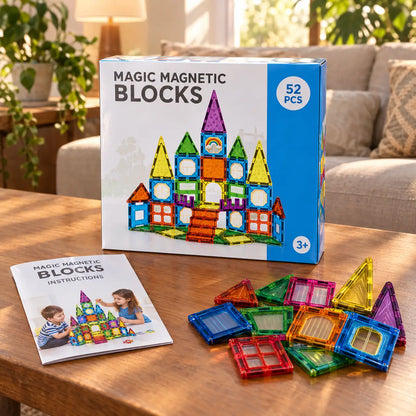 52 piece magnetic building set box with instruction booklet and loose tiles on a coffee table