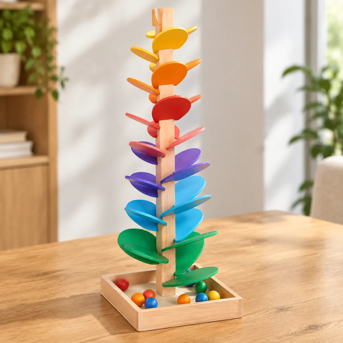 The large rainbow music tree on a table with wooden balls resting in its square tray