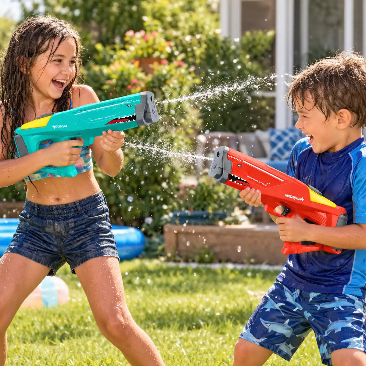 Two children in a water fight with the red and green shark water blasters