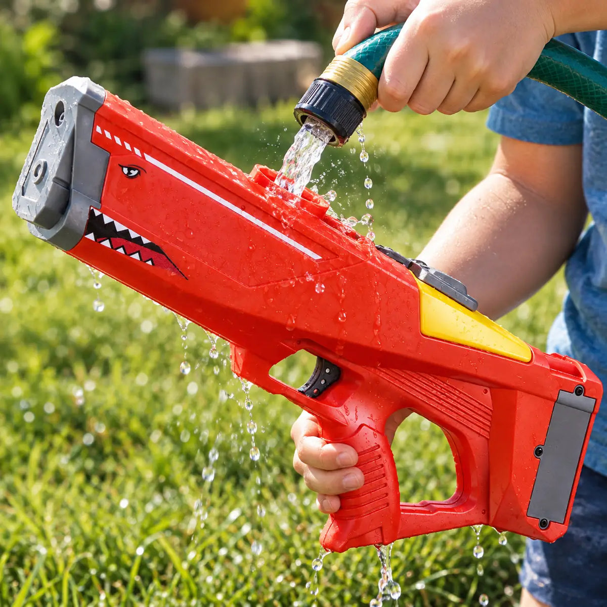 Child filling the shark water blaster tank from a garden hose